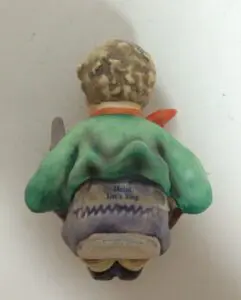 Back view of a figurine with text.