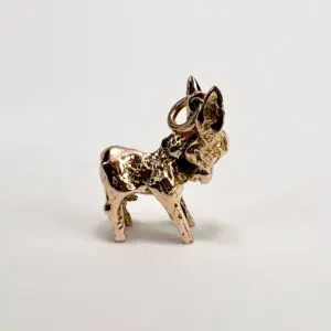 Bronze donkey charm on white background.