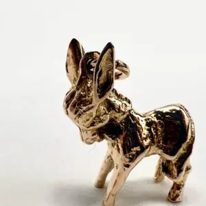 Golden donkey figurine on a white background.