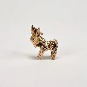 Gold donkey figurine on white background.