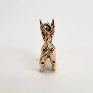 Golden donkey figurine with loop on top.