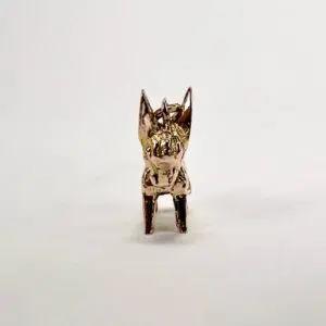 Gold animal figurine on white background.