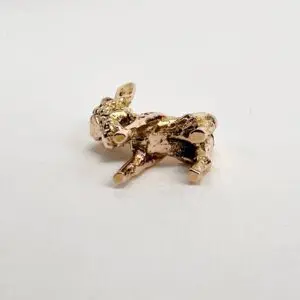 Golden rabbit figurine on a white background.