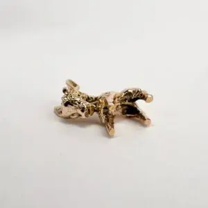 Golden cow figurine on white background.