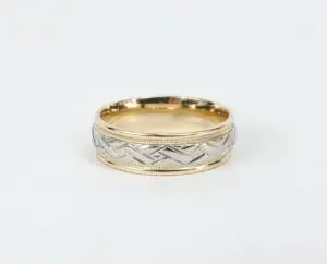 Gold and silver patterned wedding ring.
