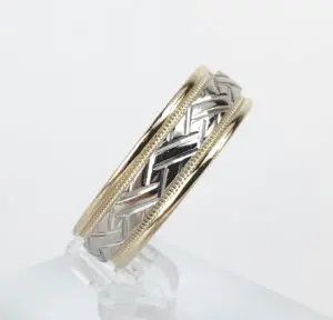 Gold and silver braided ring on display.