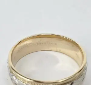 Gold and silver ring with engraving inside.