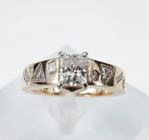 Gold ring with geometric diamond accents.