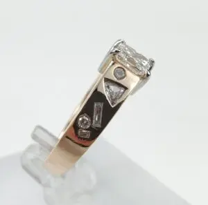 Gold ring with various shaped diamonds.
