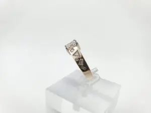 Gold ring with geometric diamond accents.