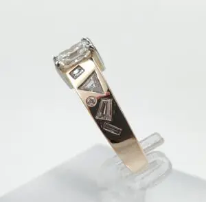Gold ring with geometric diamond accents.