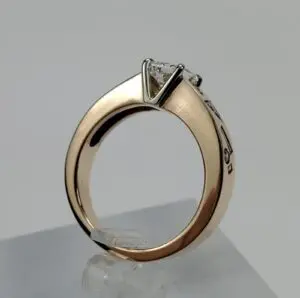 Gold ring with a diamond solitaire setting.