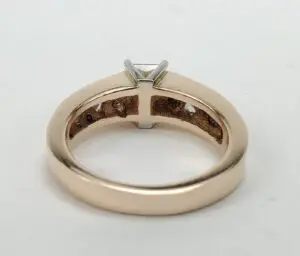 Gold ring with a solitaire diamond setting.