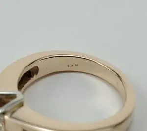 Gold ring with "14K" engraving inside band.