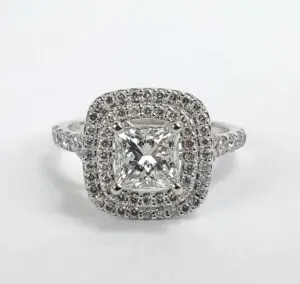 Diamond ring with square halo setting.