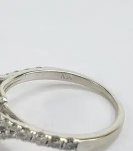 Silver ring with engraved initials "KT".