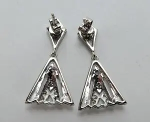 Silver triangular earrings with geometric design.