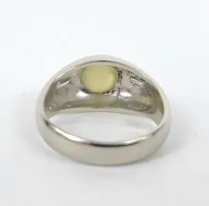 Silver ring with yellow gem inside.