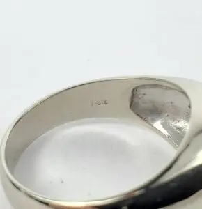 Silver ring with "14K" engraving inside.