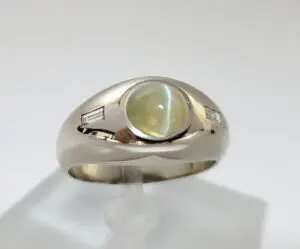 Silver ring with yellow gemstone and diamonds.