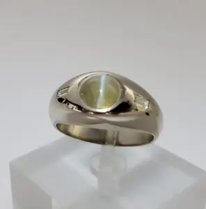 Silver ring with a green gemstone centerpiece.