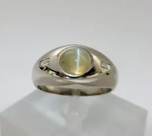 Silver ring with yellow gemstone center.