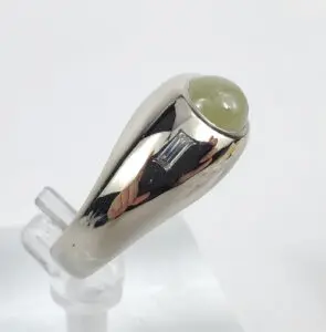 Silver ring with green gemstone cabochon.