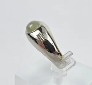 Silver ring with gemstone and rectangular accent.