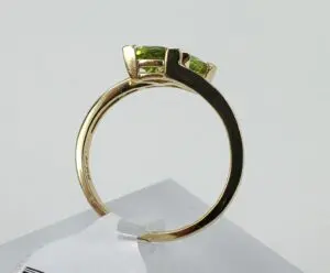 Gold ring with green gemstone setting.