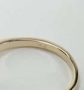 14K gold ring on white background.