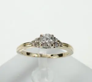 Gold ring with three diamond stones.