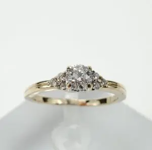 Gold ring with clustered diamond setting.