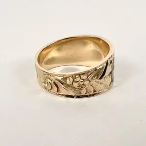 Gold ring with floral engraved design.