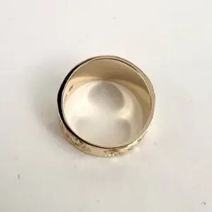 Gold ring with engraved floral design.