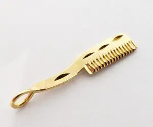 Gold comb-shaped pendant with loop handle.