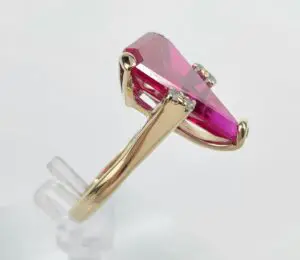 Gold ring with large pink gemstone.