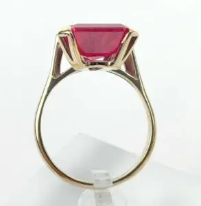 Gold ring with a large red gemstone.