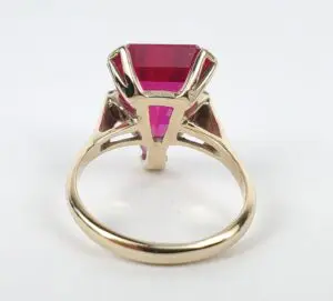 Gold ring with large red gemstone.