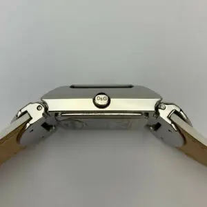 Silver watch with tan leather straps.