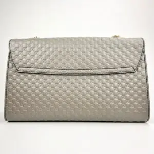 Gray quilted handbag with textured pattern.