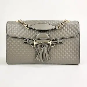 Quilted gray handbag with tassel accents.
