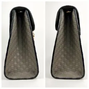 Side view of a patterned designer handbag.