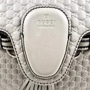 White Gucci leather bag with embossed pattern.