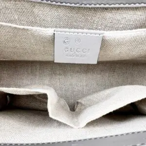 Gucci handbag interior with label tag.