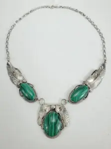 Silver necklace with green stone pendants.
