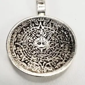 Silver pendant with intricate circular design.