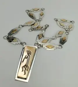 Silver and gold necklace with tribal design.