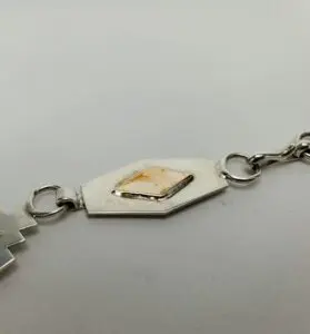 Silver bracelet with geometric design detail.
