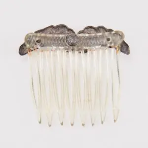 Ornate vintage hair comb with metal detailing.