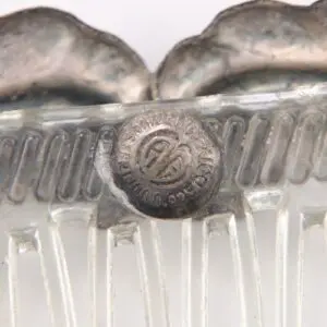 Metal and plastic vintage hair comb close-up.